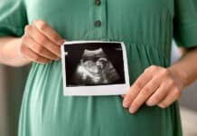 ultraäänikuva sikiöstä naisen vatsan edessä